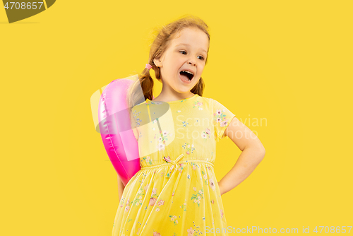 Image of Beautiful emotional little girl isolated on yellow background