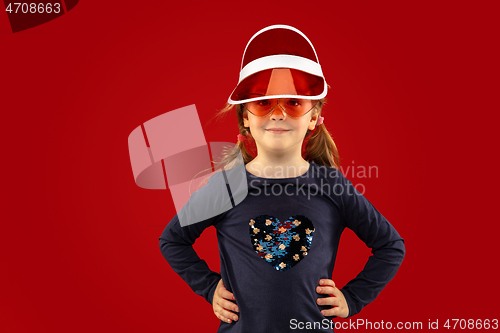 Image of Beautiful emotional little girl isolated on red background