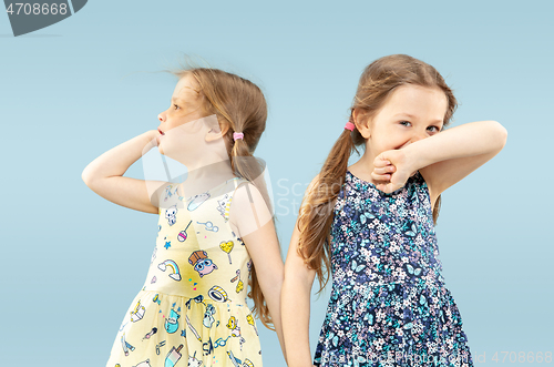 Image of Beautiful emotional little girls isolated on blue background