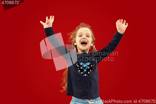 Image of Beautiful emotional little girl isolated on red background