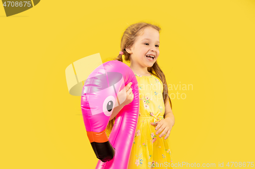 Image of Beautiful emotional little girl isolated on yellow background