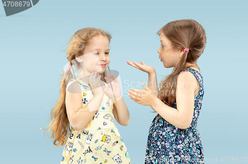 Image of Beautiful emotional little girls isolated on blue background