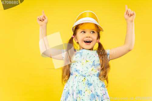 Image of Beautiful emotional little girl isolated on yellow background