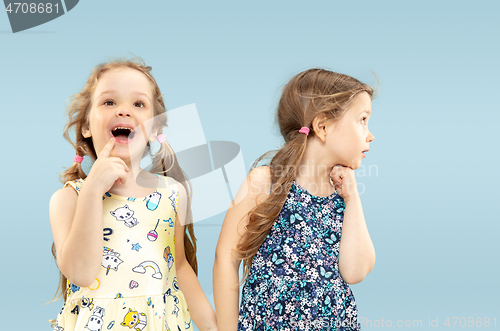 Image of Beautiful emotional little girls isolated on blue background