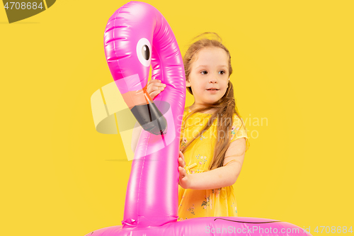 Image of Beautiful emotional little girl isolated on yellow background