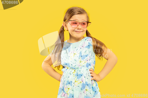 Image of Beautiful emotional little girl isolated on yellow background