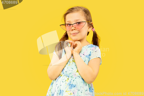 Image of Beautiful emotional little girl isolated on yellow background