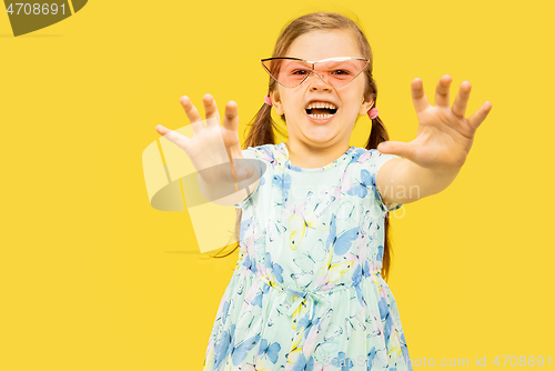 Image of Beautiful emotional little girl isolated on yellow background