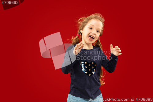 Image of Beautiful emotional little girl isolated on red background