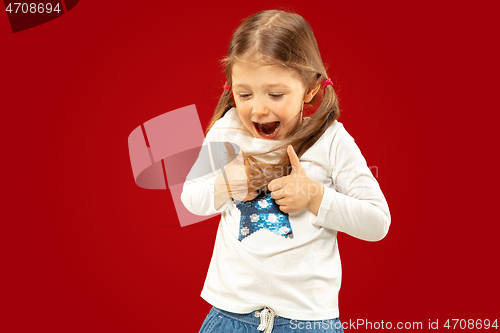 Image of Beautiful emotional little girl isolated on red background