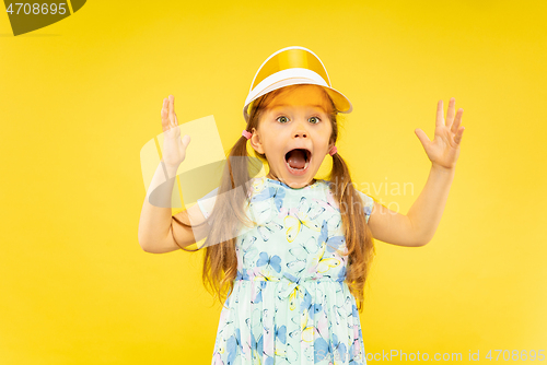 Image of Beautiful emotional little girl isolated on yellow background