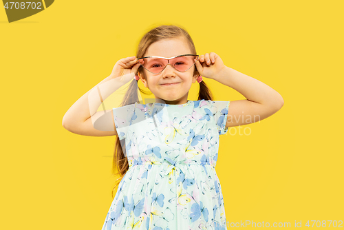 Image of Beautiful emotional little girl isolated on yellow background