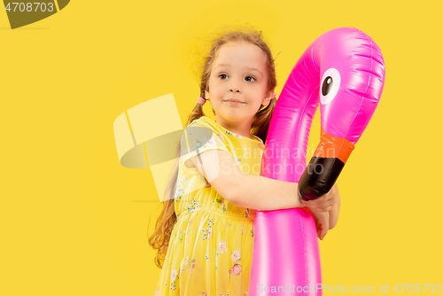 Image of Beautiful emotional little girl isolated on yellow background