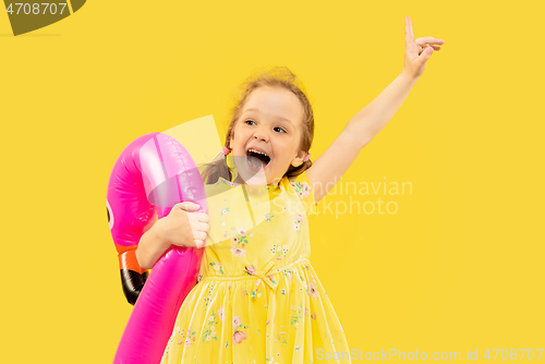 Image of Beautiful emotional little girl isolated on yellow background