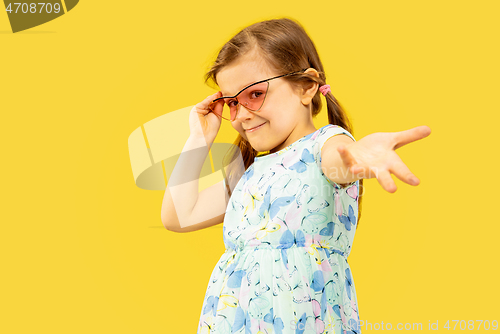 Image of Beautiful emotional little girl isolated on yellow background