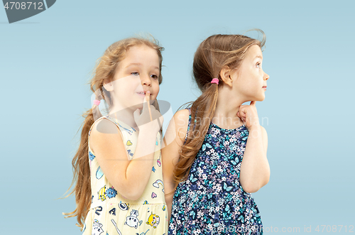 Image of Beautiful emotional little girls isolated on blue background