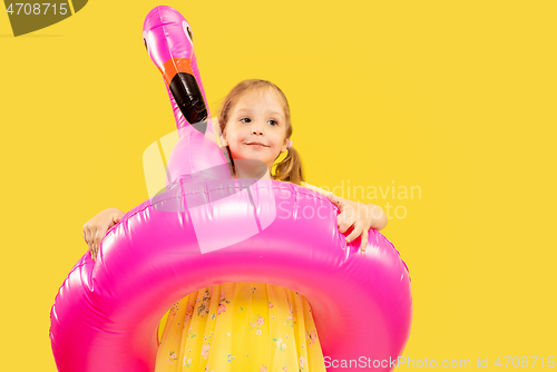 Image of Beautiful emotional little girl isolated on yellow background