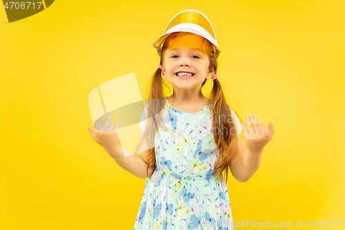 Image of Beautiful emotional little girl isolated on yellow background