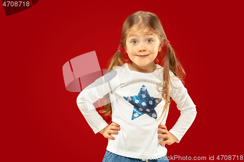 Image of Beautiful emotional little girl isolated on red background