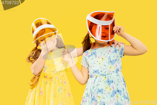 Image of Beautiful emotional little girls isolated on yellow background