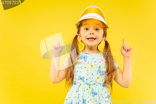 Image of Beautiful emotional little girl isolated on yellow background