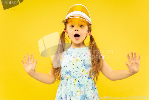 Image of Beautiful emotional little girl isolated on yellow background