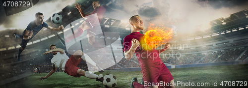 Image of Close up soccer ball in fire and football players. Creative collage