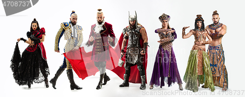 Image of Bright fairy tale characters in costumes in front of white background