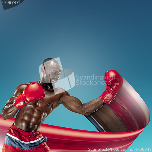 Image of Young african-american athlete training over blue background