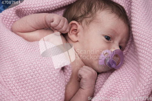 Image of One month newborn baby sleeping in bed