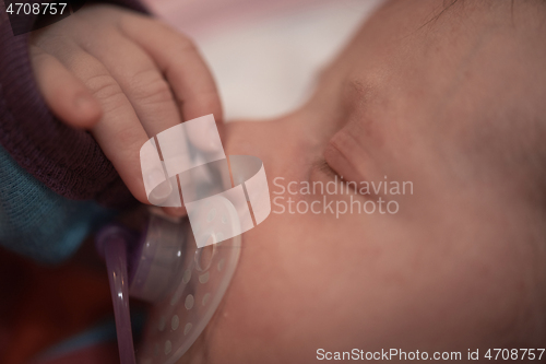 Image of One month newborn baby sleeping in bed