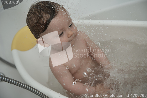 Image of cute little baby girl taking a bath