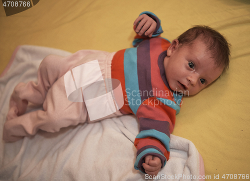 Image of One month newborn baby sleeping in bed
