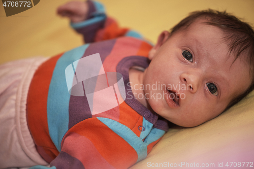 Image of One month newborn baby sleeping in bed