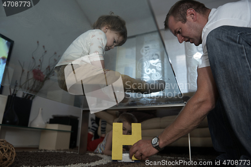 Image of Little child playing with sister at home