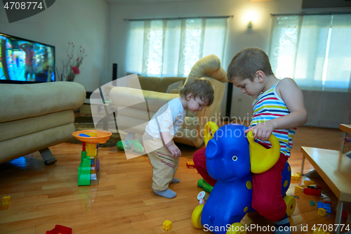 Image of Little child playing with sister at home