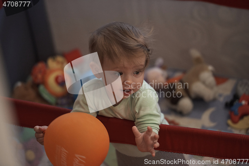 Image of cute little baby playing in mobile bed