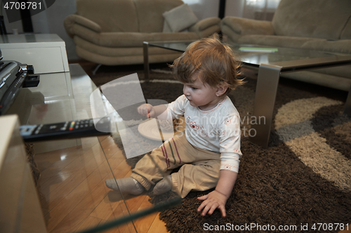 Image of Adorable cute beautiful little baby girl playing with toys at home