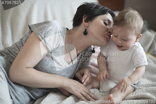 Image of mother is playing with baby at home