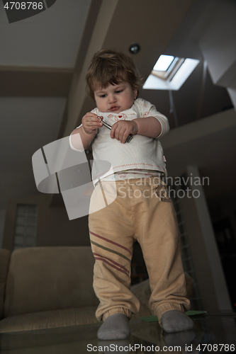 Image of Adorable cute beautiful little baby girl playing with toys at home