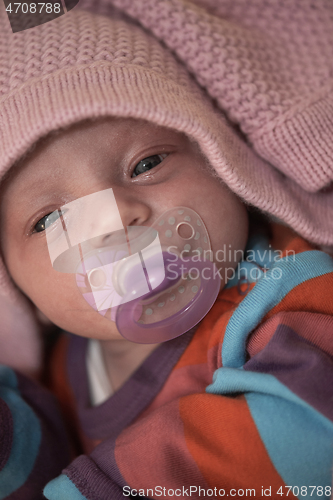 Image of One month newborn baby sleeping in bed