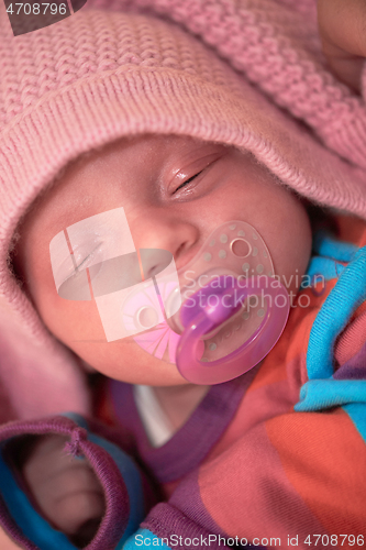 Image of One month newborn baby sleeping in bed