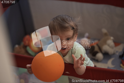 Image of cute little baby playing in mobile bed