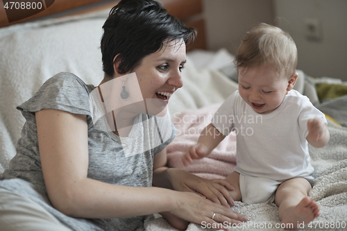 Image of mother is playing with baby at home