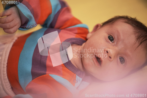 Image of One month newborn baby sleeping in bed