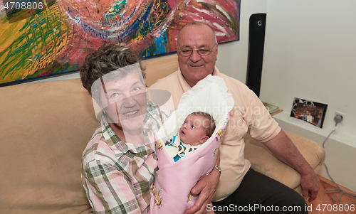 Image of family portrait with grandparents parents and baby