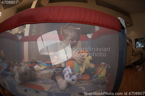 Image of cute little baby playing in mobile bed