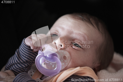 Image of One month newborn baby sleeping in bed