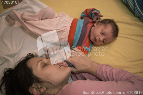 Image of mother is playing with baby at home