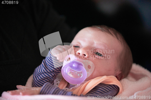 Image of One month newborn baby sleeping in bed